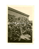 German Soldier Sitting on Pile of French Helmets, France 1940, Original WW2 Photo